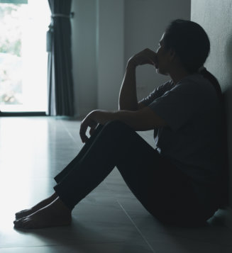 woman sitting in the corner